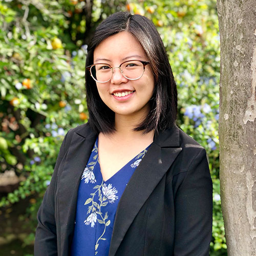 Ashley Yu posing in front of a tree